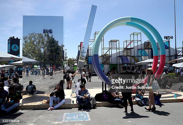 Attendees gather near a sculpture during Google I/O 2016 at Shoreline Amphitheatre on May 19, 2016 in Mountain View, California. Google CEO Sundar...