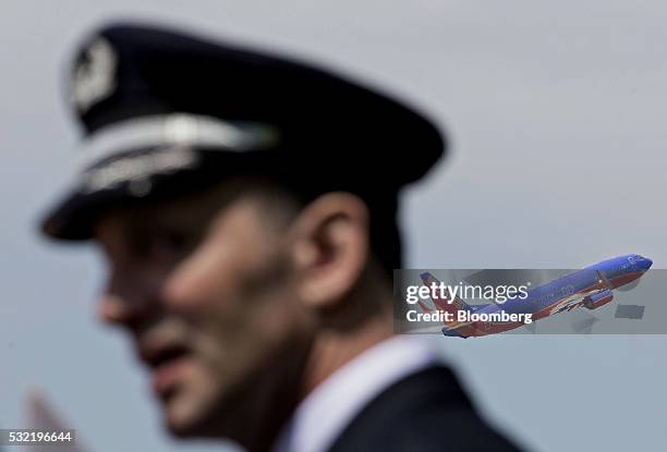 Southwest Airlines Co. Plane takes off a pilot from the Southwest Airlines Pilots' Association demonstrates outside Chicago Midway International...