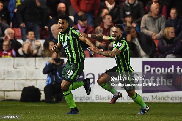 Lyle Taylor of AFC Wimbledon celebrates with teammate Callum Kennedy after scoring a goal in the first period of extra time to give his team a 3-2...