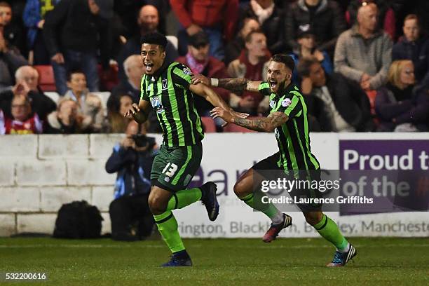 Lyle Taylor of AFC Wimbledon celebrates with teammate Callum Kennedy after scoring a goal in the first period of extra time to give his team a 3-2...