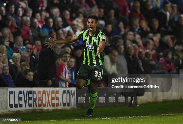 Lyle Taylor of AFC Wimbledon celebrates after scoring a goal in the first period of extra time to give his team a 3-2 aggregate lead during the Sky...