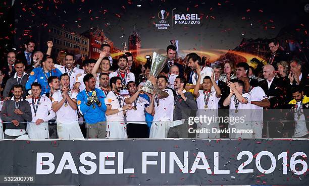 Captian Jose Antonio Reyes and Vitolo of Sevilla lift the Europa League trophy as players celebrate at the award ceremoy after the UEFA Europa League...