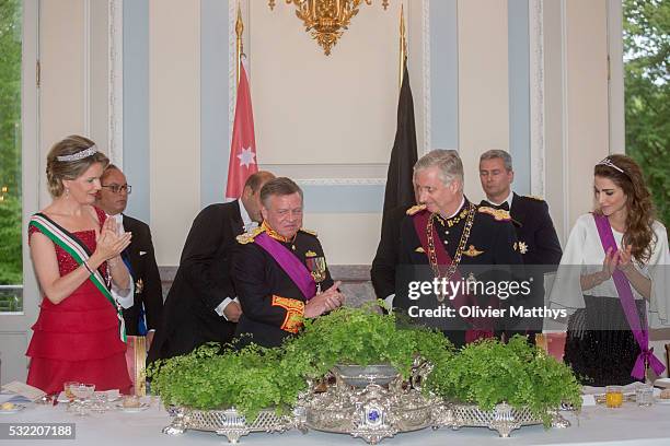 Queen Mathilde of Belgium, King Abdullah II of Jordan, King Philippe of Belgium and Queen Rania of Jordan drink a toast during the gala dinner at the...