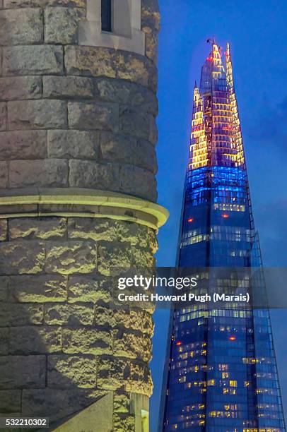 spot lit tower bridge stone. dusk's inky blue reflections in the shard's mirrored surfaces - howard tate stock pictures, royalty-free photos & images