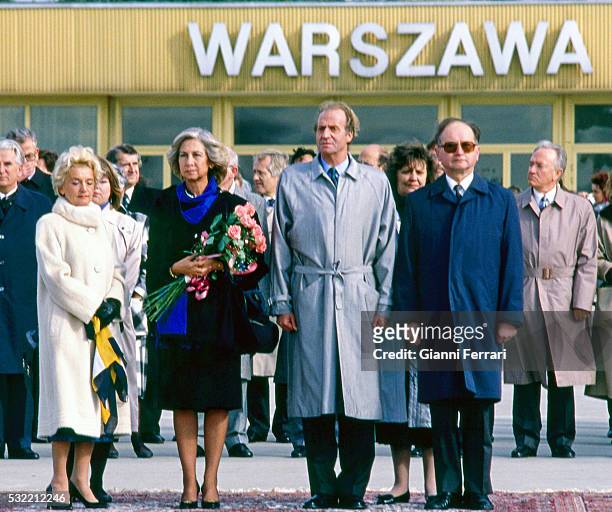 During a State visit, Queen Sofia of Spain and King Juan Carlos I of Spain are greeted at the airport by Polish President Wojciech Jaruzelski and his...