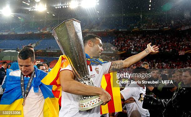 Vicente Iborra of Sevilla celebrates victory with the trophy and his fans after the UEFA Europa League Final match between Liverpool FC and Sevilla...