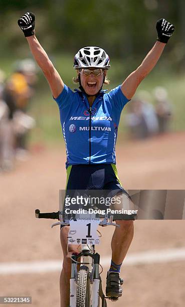 Gunn-Rita Dahle of Norway celebrates as she crosses the finish line as she won Womens Cross Country Race at the UCI Mountain Bike World Cup at the...