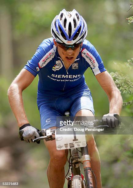 Christoph Sauser of Switzerland rides to victory during the Men's Cross Country Race at the UCI Mountain Bike World Cup at the Angel Fire Resort on...
