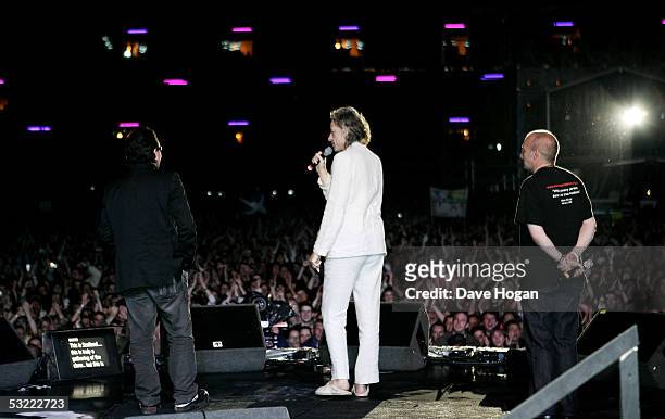 Musicians Bono, Sir Bob Geldof and Midge Ure appear on stage following the Live 8 Edinburgh concert at Murrayfield Stadium on July 6, 2005 in...
