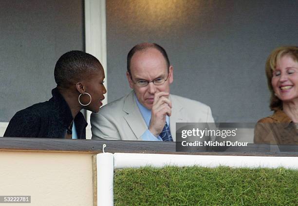 Prince Albert of Monaco chats with Nicole Coste as they watch a match from his private box at the Monaco Tennis Open in April 2002 in Monaco. Prince...