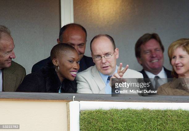 Prince Albert of Monaco chats with Nicole Coste as they watch a match from his private box at the Monaco Tennis Open in April 2002 in Monaco. Prince...
