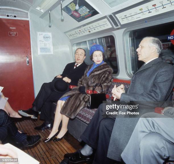 Queen Elizabeth II travels on a tube train after the official opening ceremony of London Underground's Victoria Line, 7th March 1969.