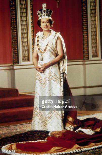 Queen Elizabeth II poses for a silver jubilee portrait in the Throne Room of Buckingham Palace, 6th February 1977.