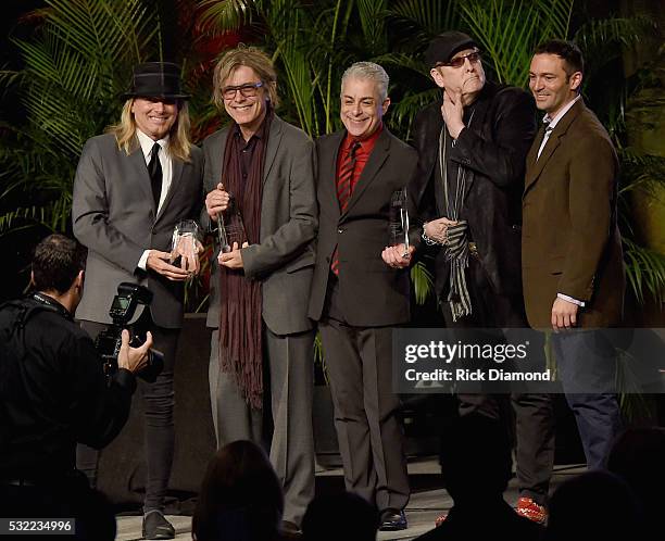 Cheap Trick's Robin Zander, Tom Petersson and Rick Nielsen receive the Chairman's Award for Sustained Creative Achievement from James Donio President...