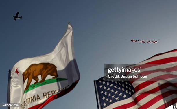 Plane pulls a banner in support of Republican presidential candidate Donald Trump by a campaign rally for Democratic presidential candidate Sen....