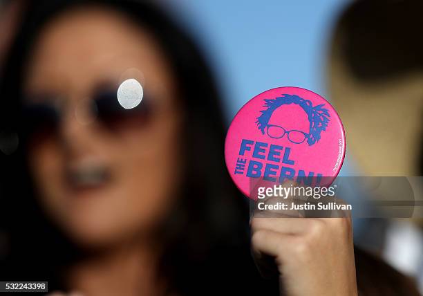 Supporter of Democratic presidential candidate Sen. Bernie Sanders holds a campaign button during a campaign rally at Waterfront Park on May 18, 2016...