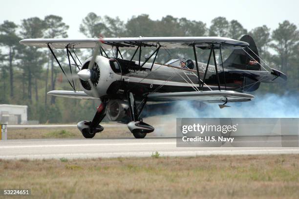 In this handout photo provided by the U.S. Navy and released on July 11 Jimmy Franklin pilots his jet-powered Waco bi-plane to a landing at the...