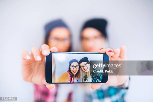 two cool friend taking selfie - cute girlfriends stock pictures, royalty-free photos & images