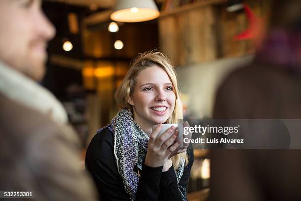 woman having coffee with friends in cafe - coffee shop friends stock-fotos und bilder