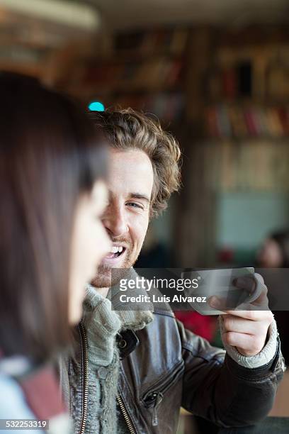 man having coffee with female friend in cafe - couple beard coffee stock-fotos und bilder