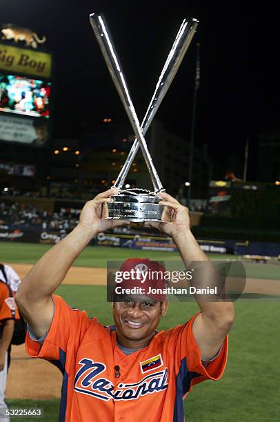 National League All-Star Bobby Abreu of the Philadelphia Phillies celebrates with the trophy after winning the 2005 Major League Baseball Home Run...