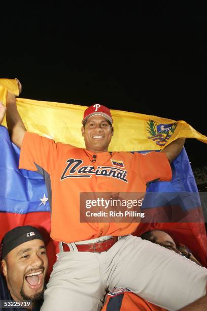 Philadelphia Phillie Bobby Abreu of Venezuela celebrates winning the 2005 Major League Baseball Home Run Derby with Johan Santana of the Minnesota...
