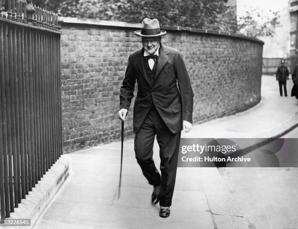 British statesman Winston Churchill makes his way to Number 10 Downing Street for a meeting, September 1922.