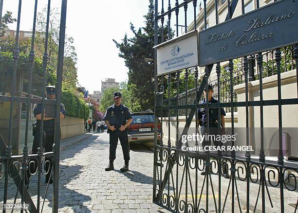 Policemen guard the Italian Cultural Institute after a small bomb exploded early 12 July 2005, outside the building in Barcelona. A policeman was...