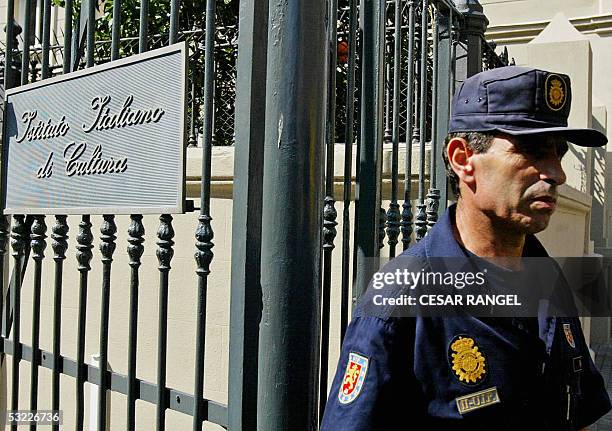 Policeman guards the Italian Cultural Institute after a small bomb exploded early 12 July 2005, outside the building in Barcelona. A policeman was...