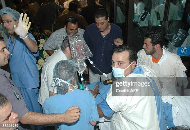 Doctors move colonel Elias el-Beissari, the security chief of Defence Minister Elias Murr, to another room following an operation at hospital in...