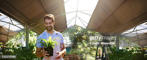 he takes pride in his plants - plant nursery stock pictures, royalty-free photos & images