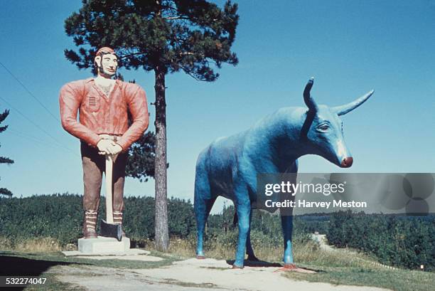 Statue of American folklore lumberjack Paul Bunyan and 'Babe the Blue Ox' in Michigan, USA, circa 1960.