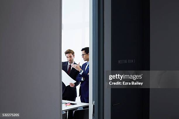 businessmen discussing plans in smart office. - office doorway stock pictures, royalty-free photos & images