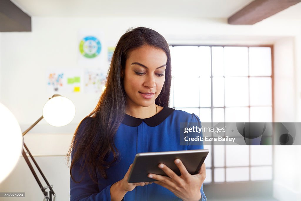 Young businessman using a tablet in modern office