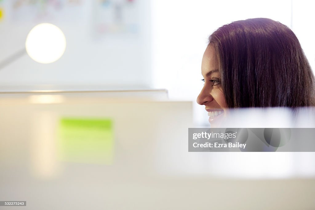 Close up of a female employee working at her desk.