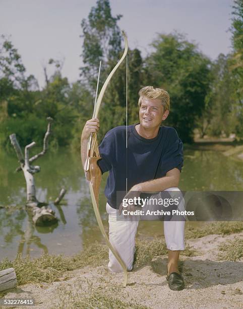 American actor and singer Troy Donahue holding a bow and arrow, circa 1960.