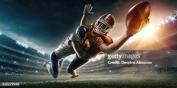 american football player being tackled - touchdown stock pictures, royalty-free photos & images