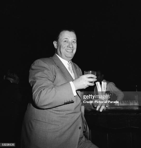 American restaurant owner Toots Shor has a drink at the bar in his restaurant, New York, New York, 1950s.