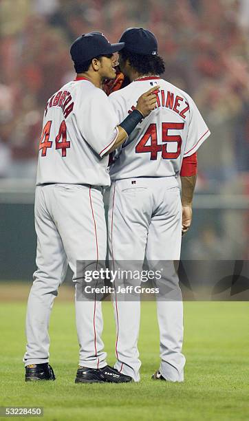 Pitcher Pedro Martinez of the Boston Red Sox talks with shortstop Orlando Cabrera during the American League Division Series with the Anaheim Angels,...