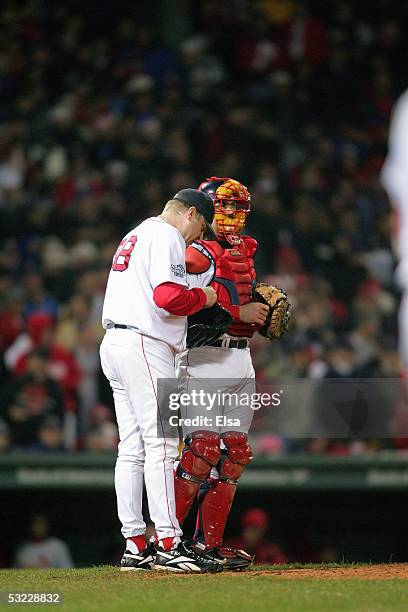 Curt Schilling and Jason Varitek of the Boston Red Sox talk during game two of the 2004 World Series against the St. Louis Cardinals on October 24,...