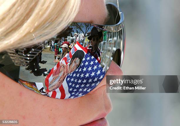 Michael Jackson fan Wiedjai Sewgobind of The Netherlands is reflected in the sunglasses of fellow fan Tina Sorenson of Norway while they wait outside...