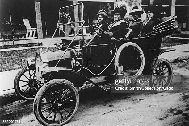 Photograph of Sarah Breedlove driving a car, she was better known as Madam C.J. Walker, the first woman to become a self-made millionaire in the...