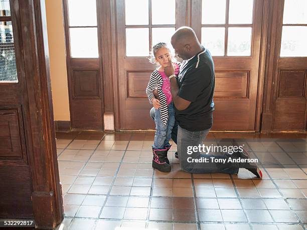 father comforting his crying daughter - on knees crying stock pictures, royalty-free photos & images