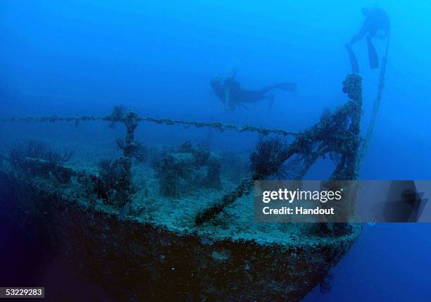 In this handout photo provided by the Florida Keys News Bureau, divers swim at the shipwreck Spiegel Grove in the Florida Keys National Marine...