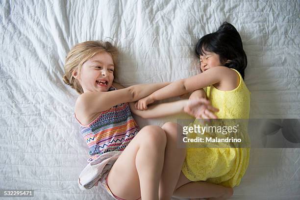 girls tickling each other - rough housing stock-fotos und bilder