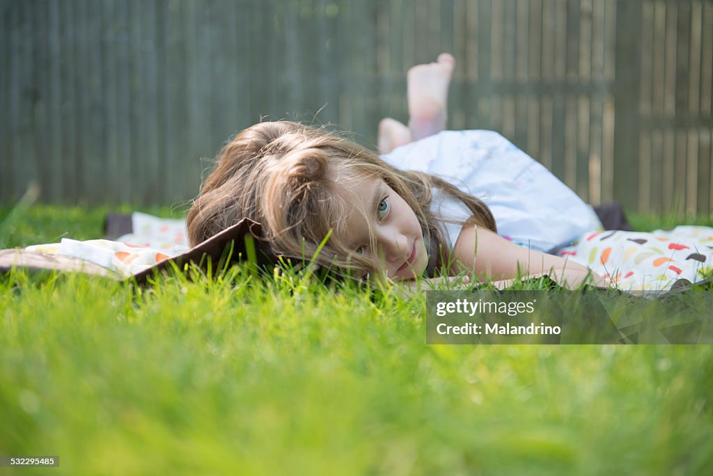 Girl lying down on the grass