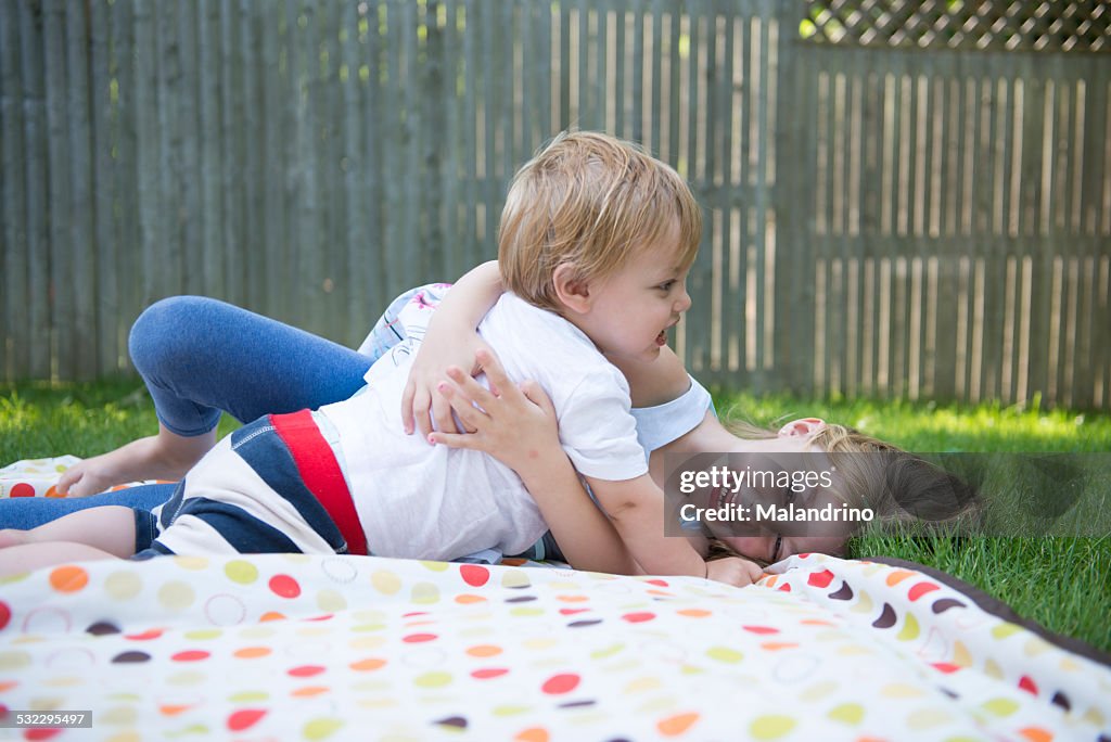 Boy and Girl huging and playing in the grass