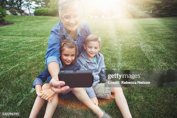 grandma and grandkids taking selfie - illinois family stock pictures, royalty-free photos & images