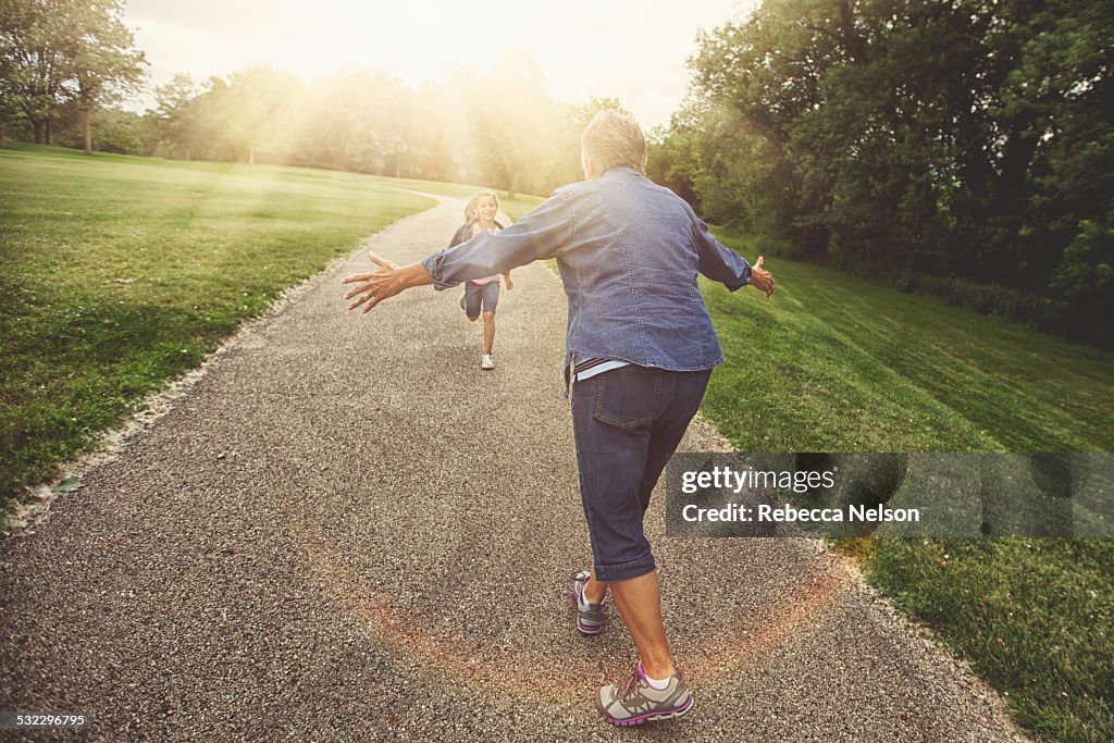 Granddaughter running to grandma for a hug