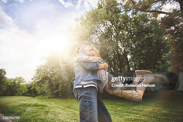 grandma hugging grandson - family in park outside stock pictures, royalty-free photos & images